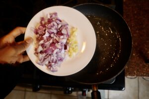red onion and garlic on a white plate