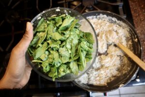 fresh spinach on top of creamy artichoke mixture