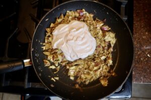 cashew cream cheese sauce on top of artichoke sautéed