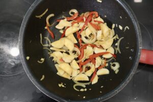 sautéed herbs with king trumpet mushrooms in a pan