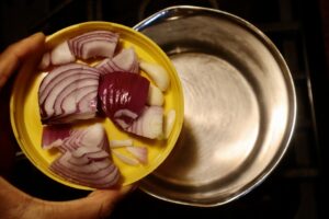 red onion and garlic on top of boiling water