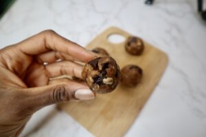 Chocolate chip energy ball in between two fingers 