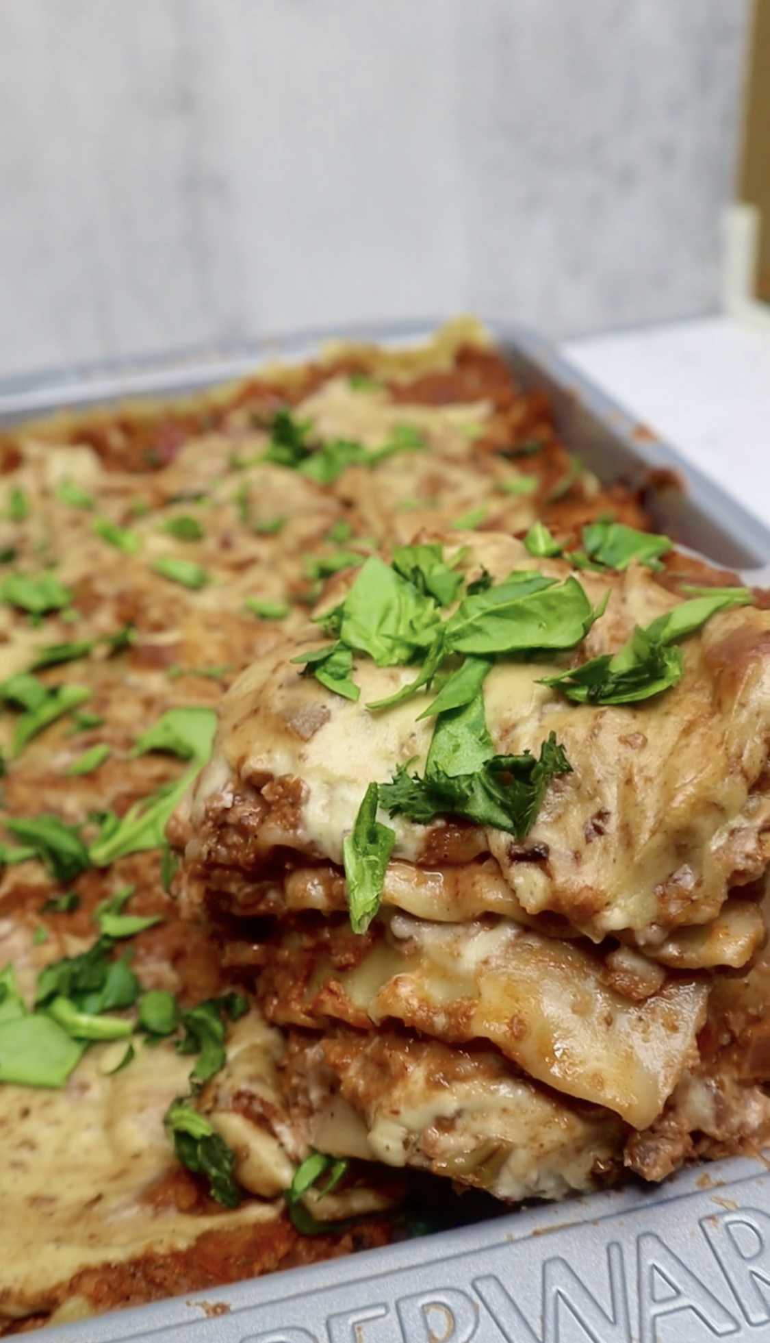 Slice of vegan lasagna lifted with spatula