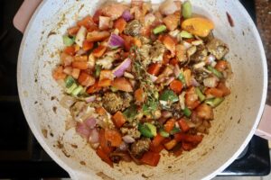 sautéed herbs and veggies in a pan
