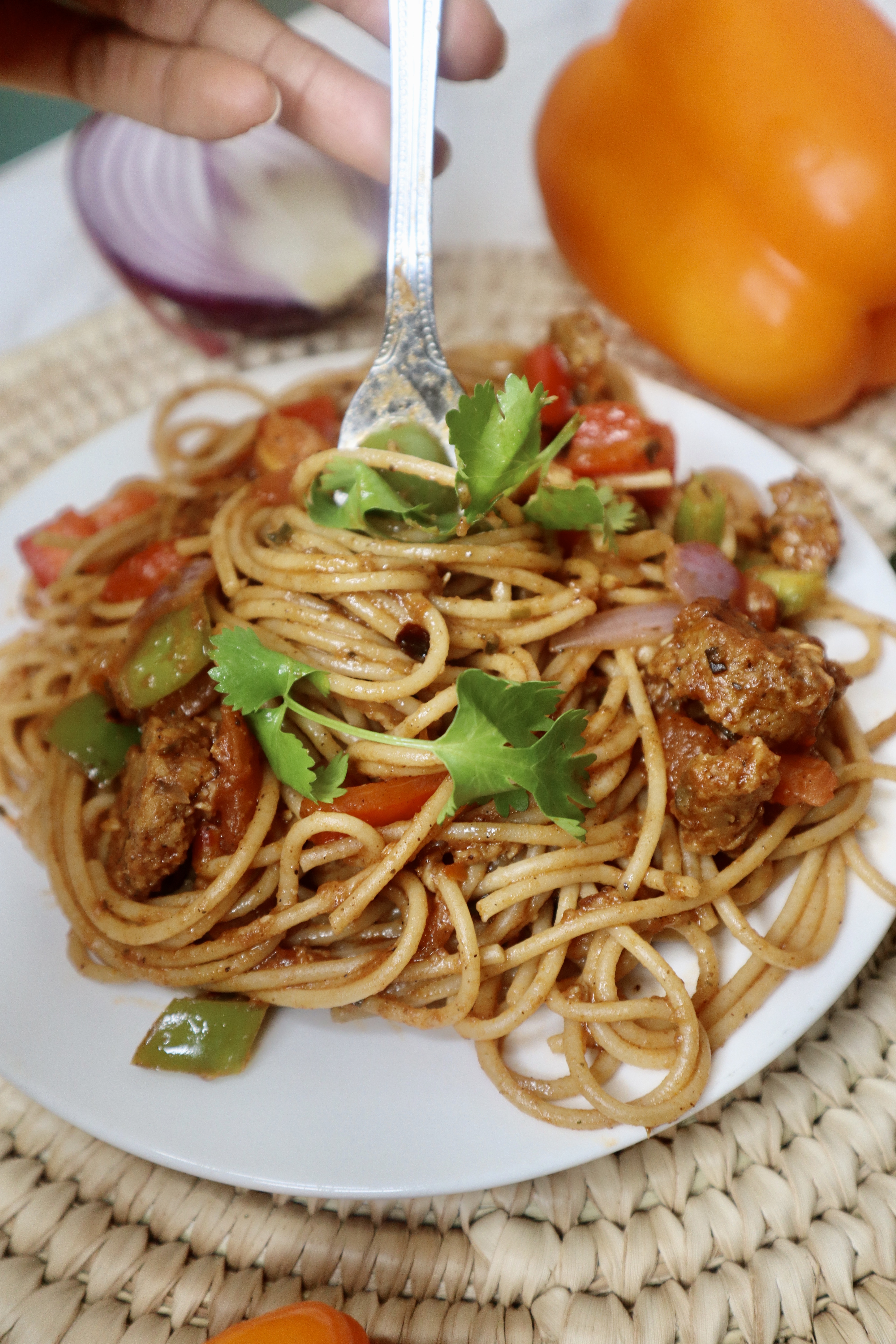 vegan haitian spaghetti twirled on a fork