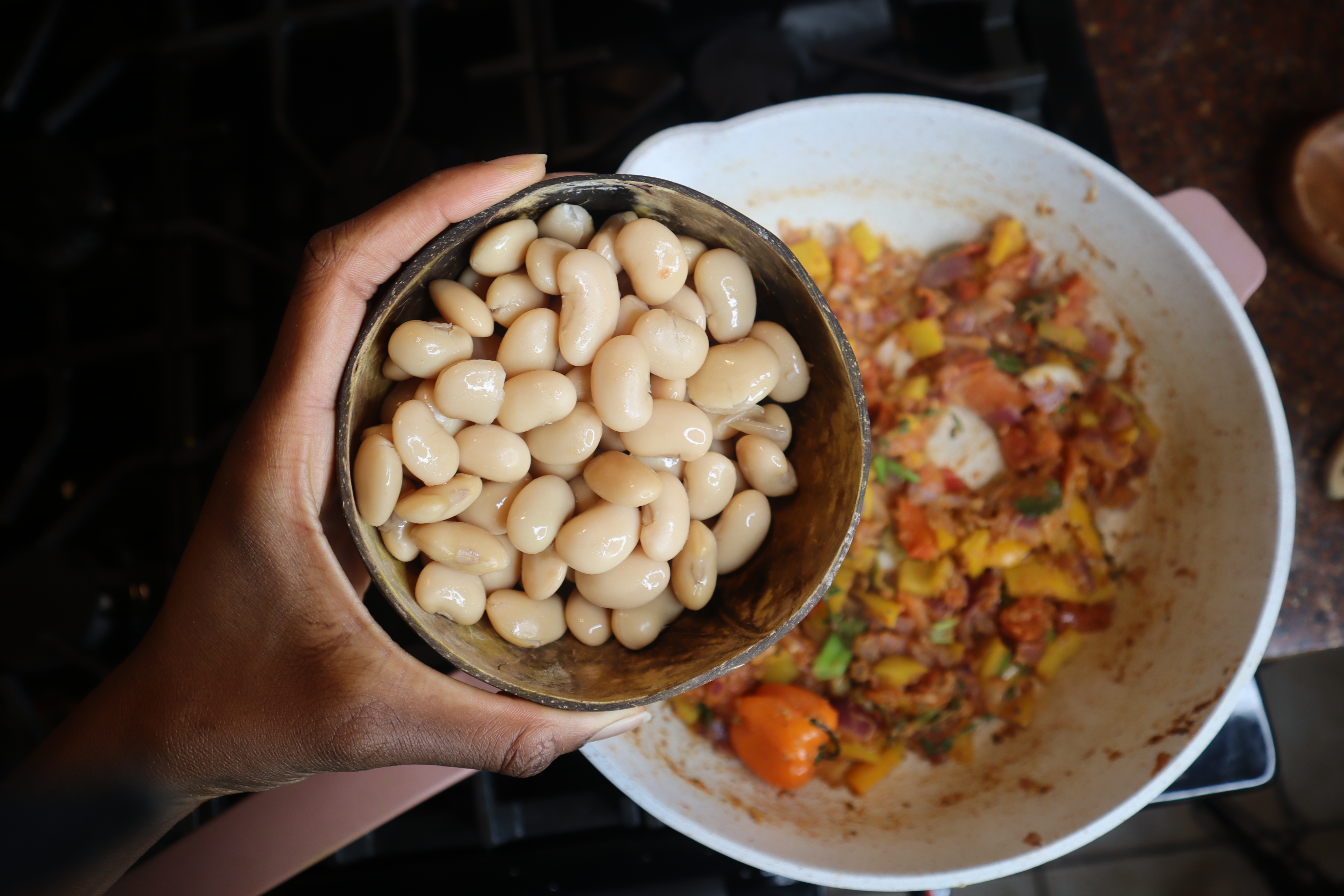 butter beans in coconut bowl over pan
