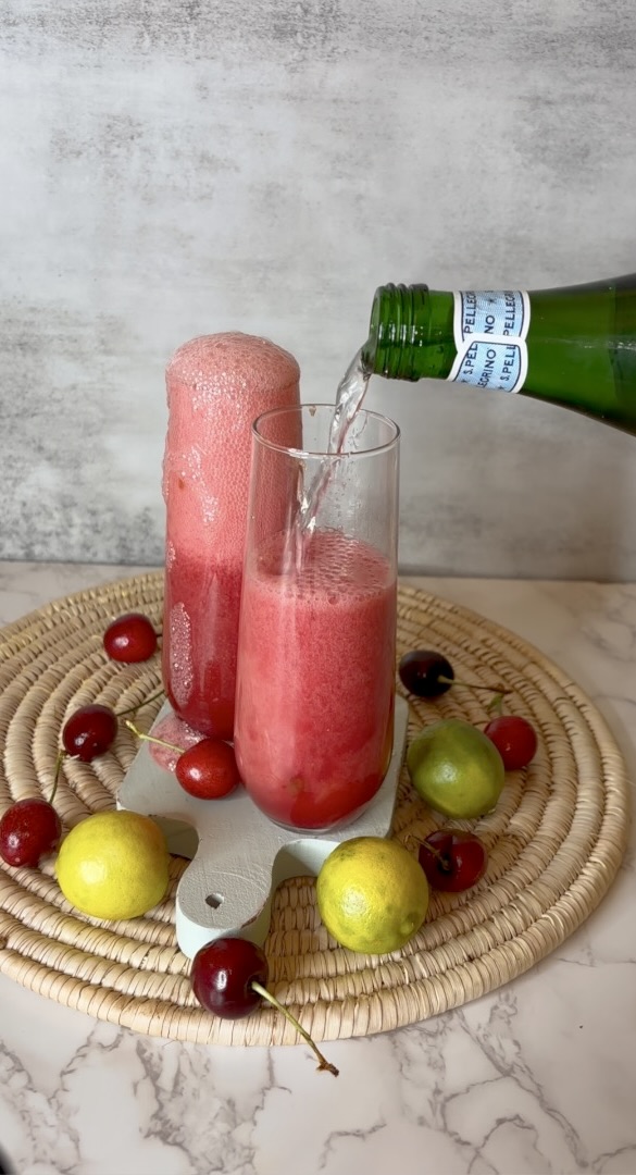 cherry limeade water pouring into glass