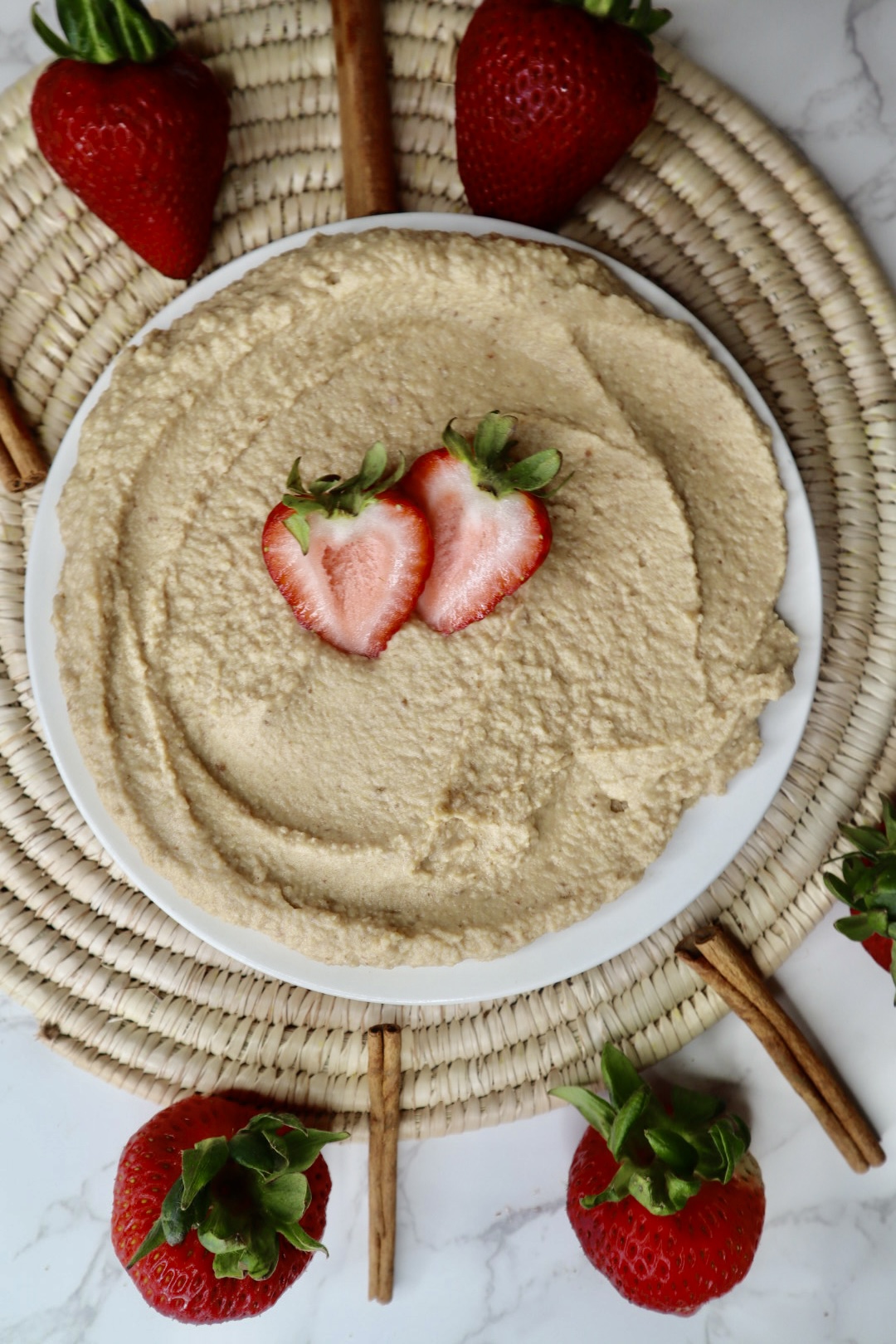 Vanilla dessert hummus topped with strawberries