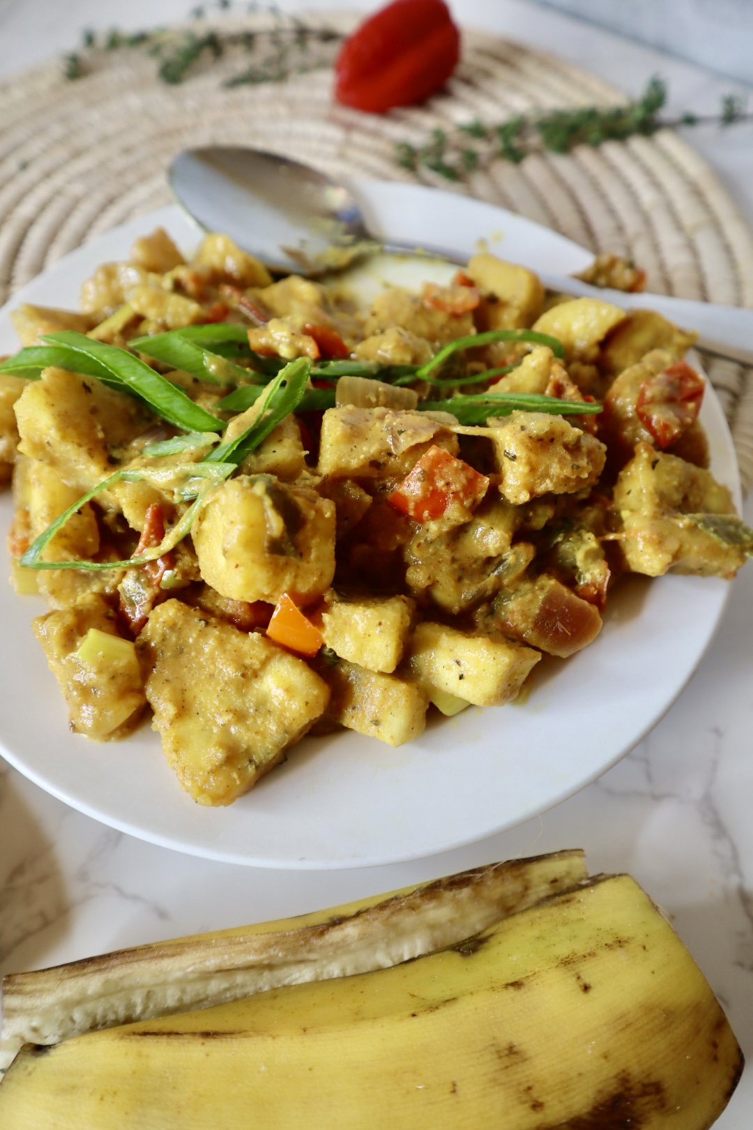 Caribbean plantain curry on a white plate