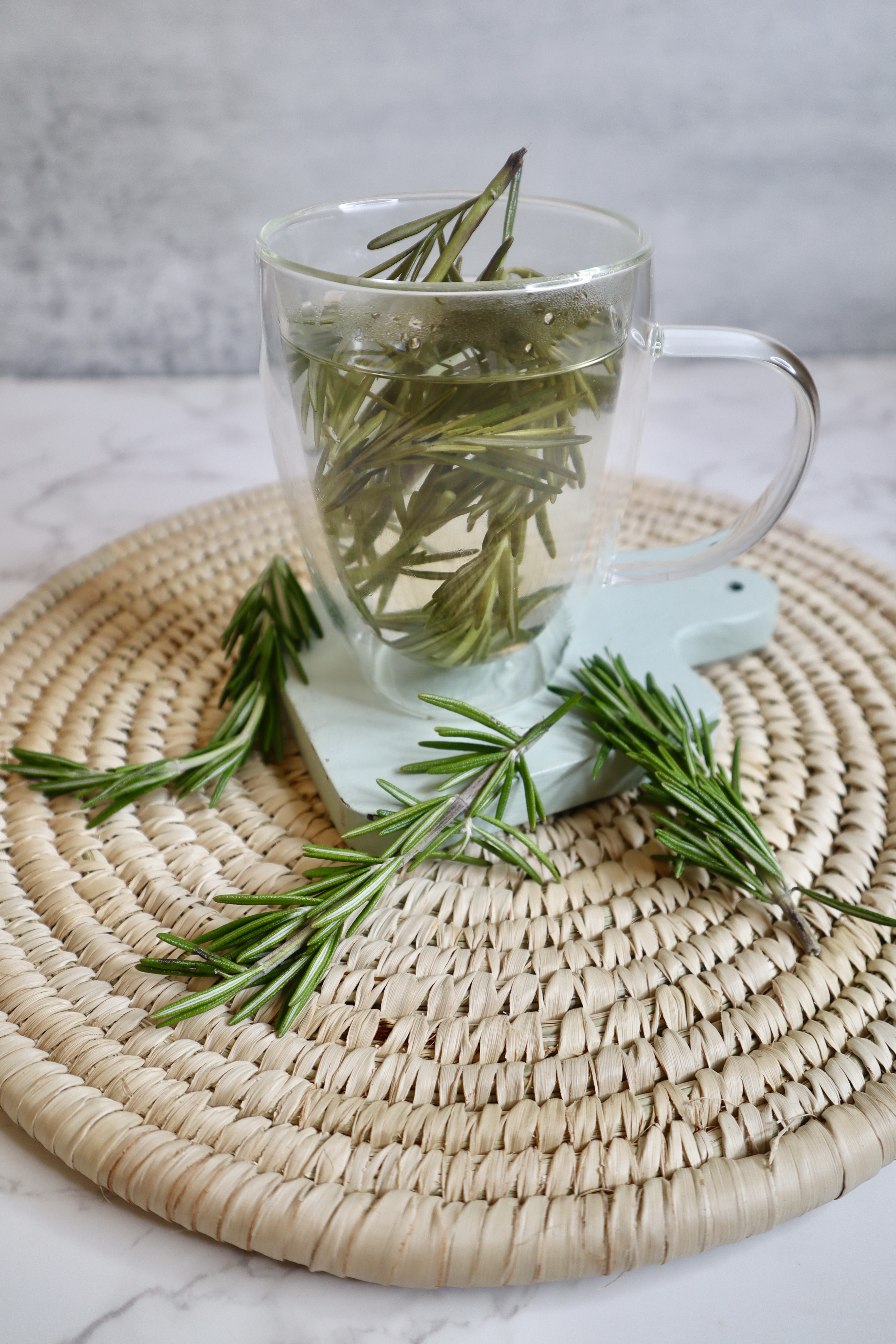 fresh rosemary in a clear glass tea cup