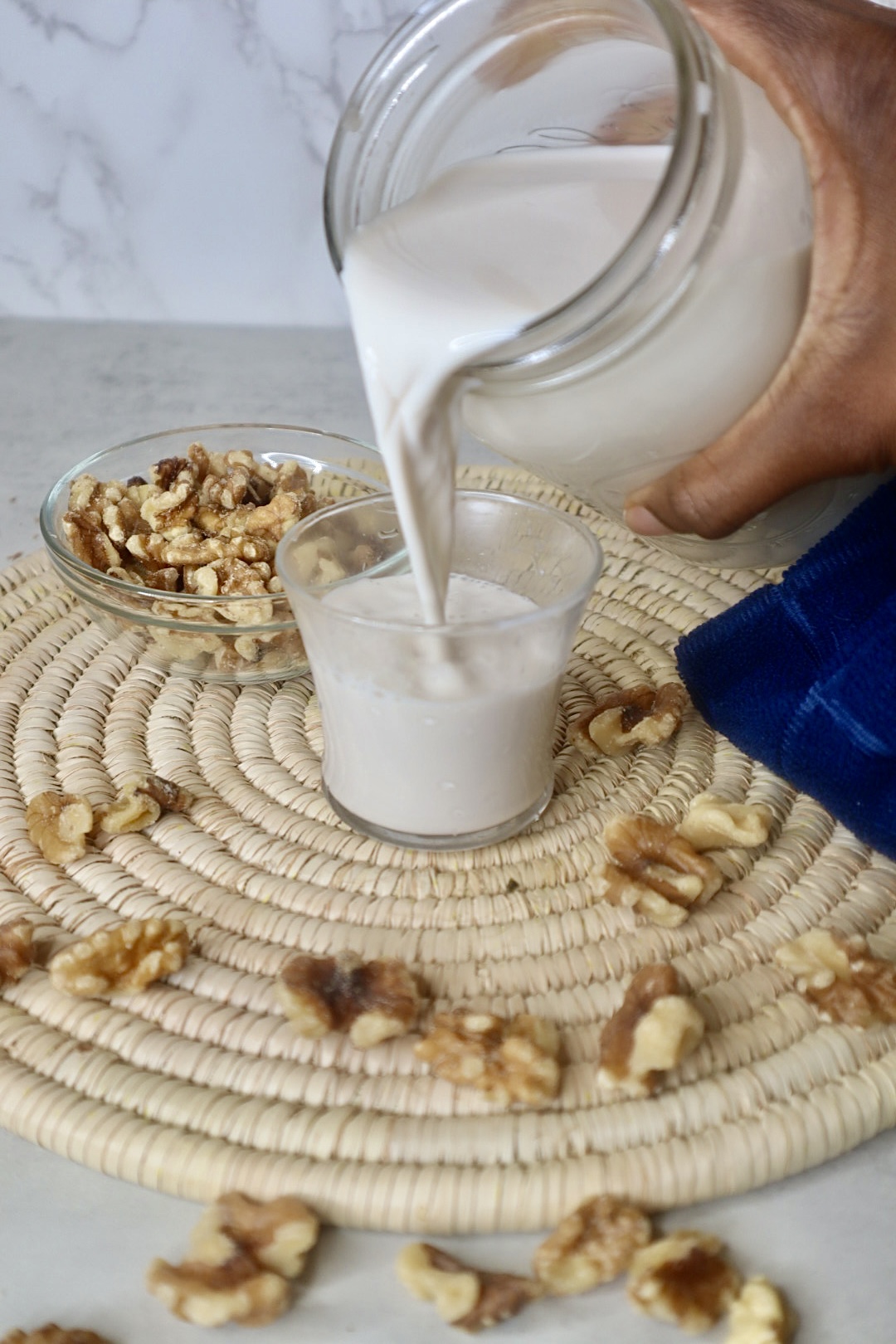 walnut milk pouring into small glass