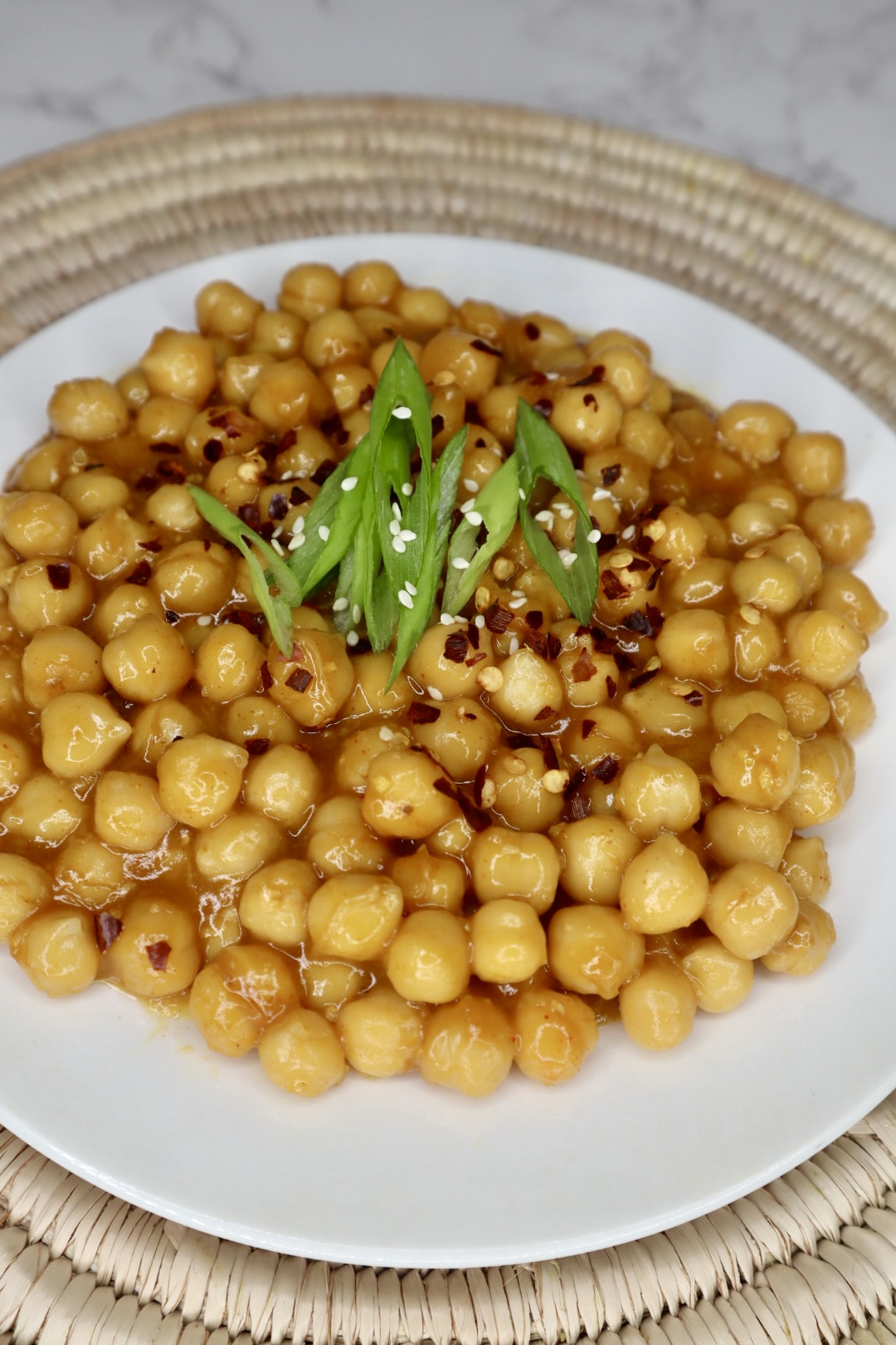 orange chickpeas topped with green scallion