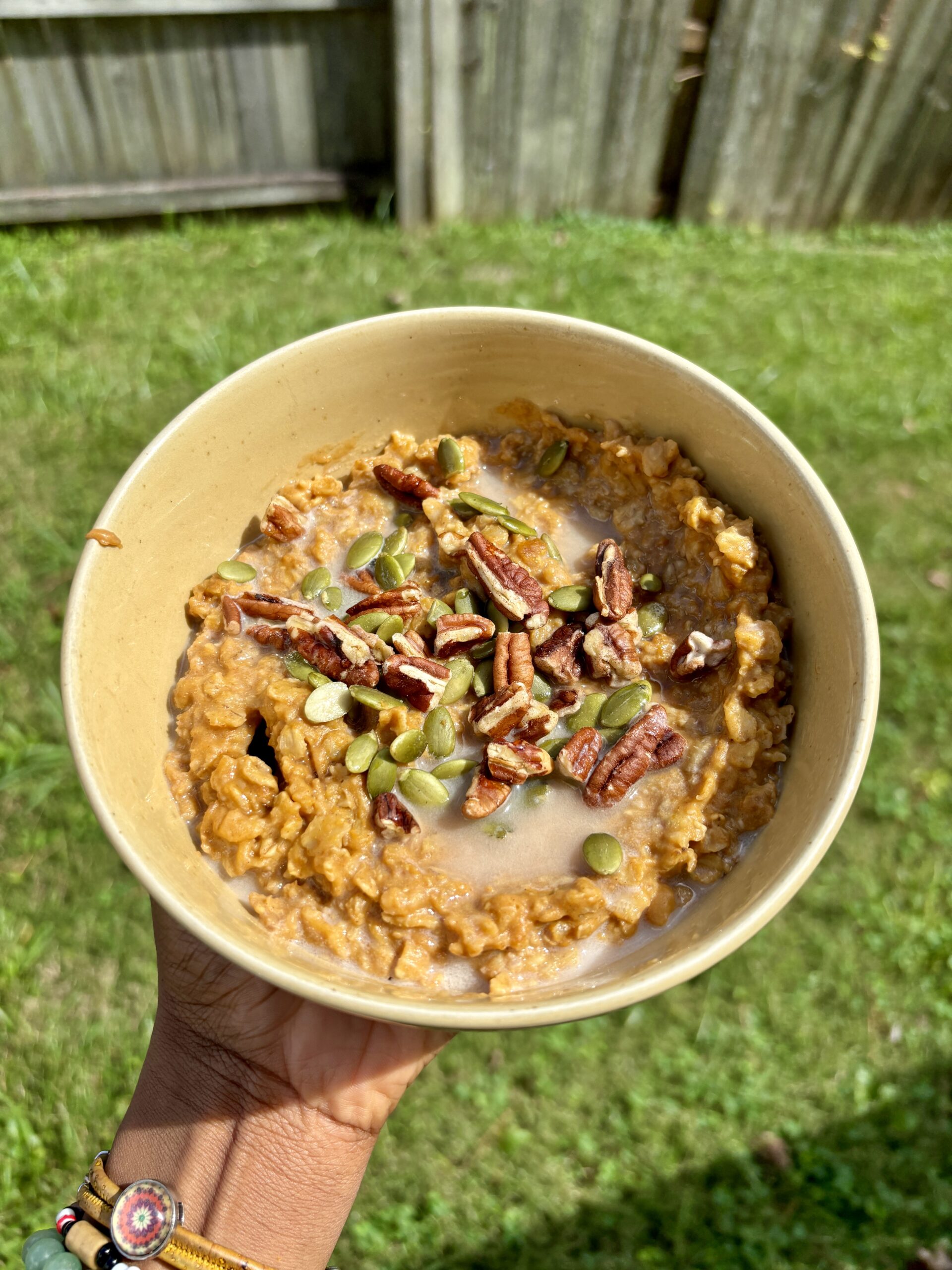 pumpkin spice oatmeal topped with pumpkin seeds and pecans