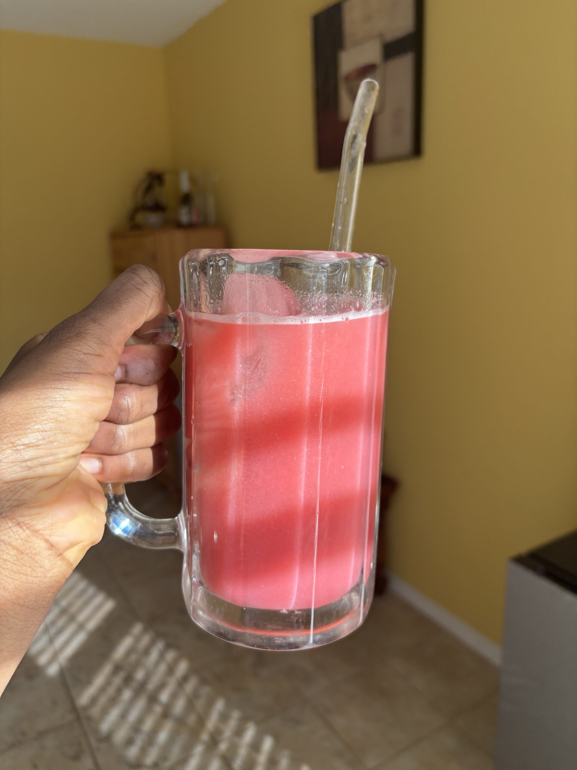 cranberry fruit punch in a glass cup with straw