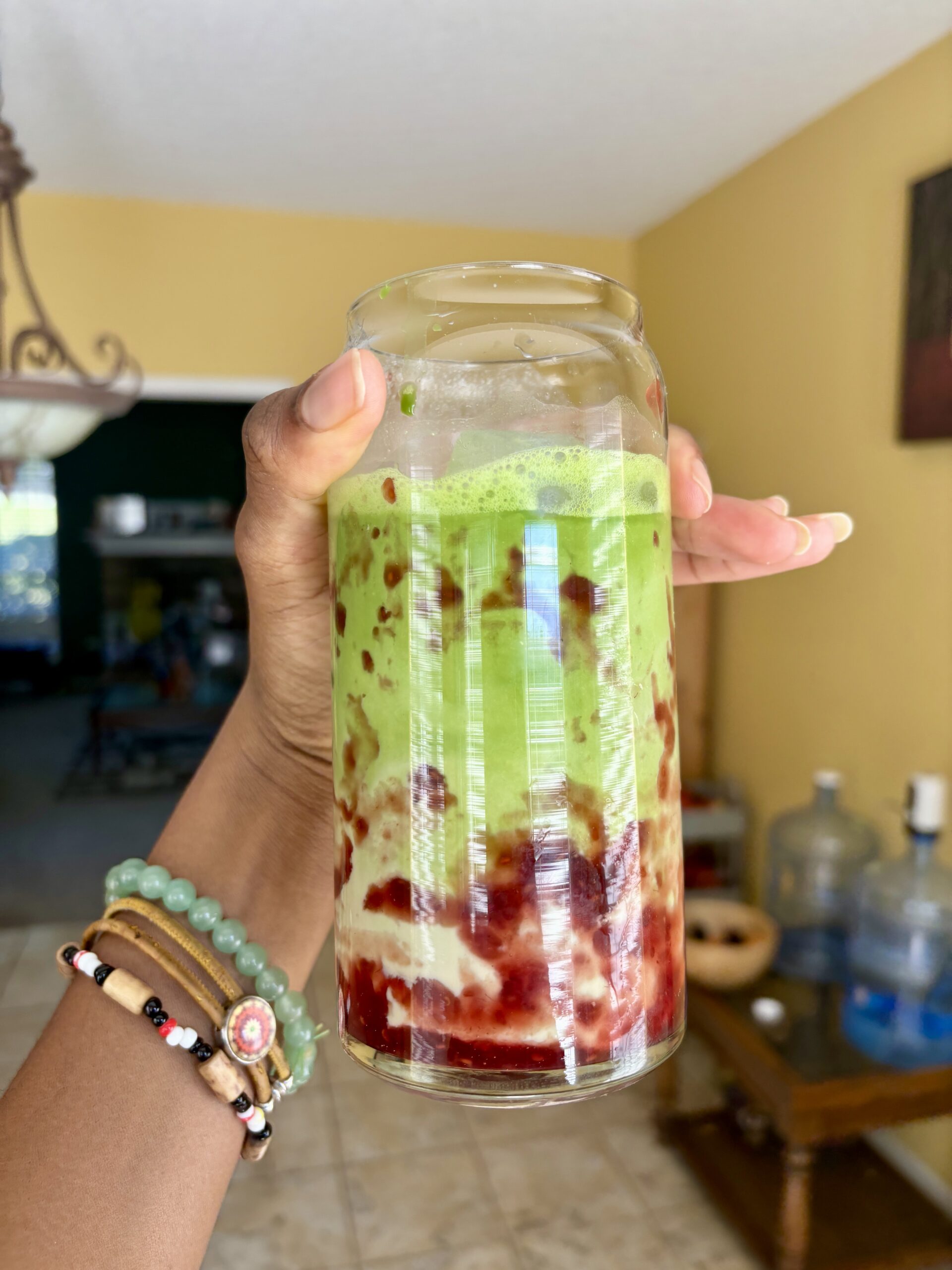 iced strawberry matcha latte in a glass cup