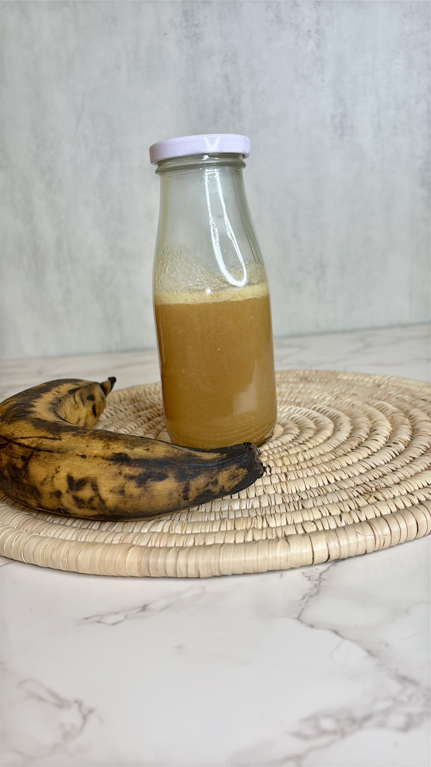 homemade plantain syrup in a small milk bottle