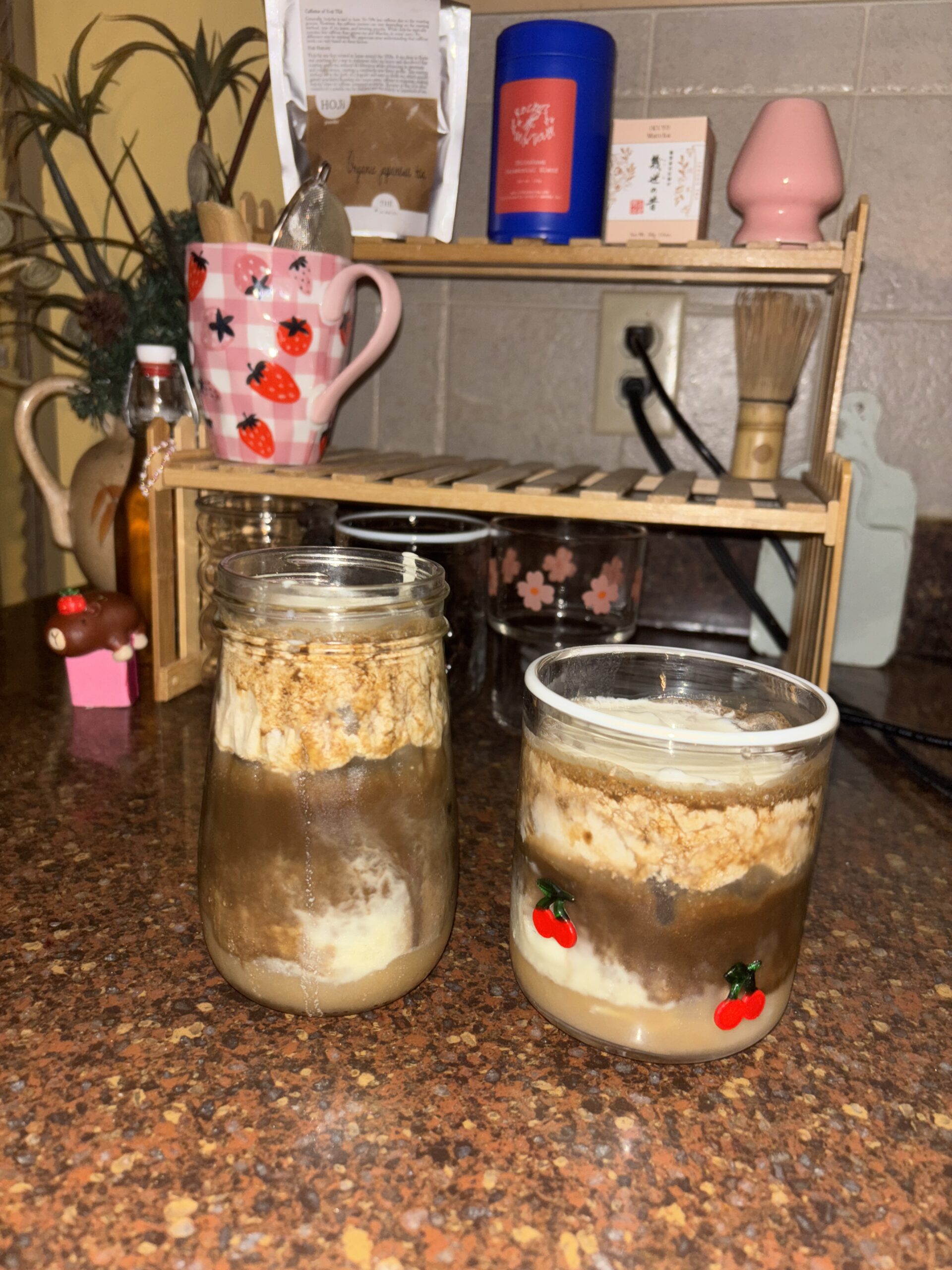 two hojicha lattes in front of matcha stand