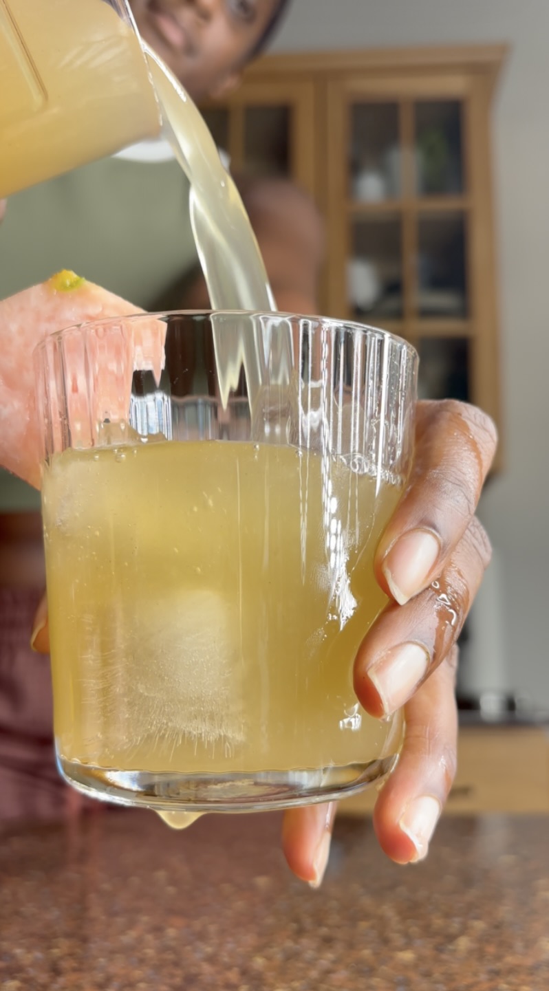 pineapple skin tea being poured into a glass