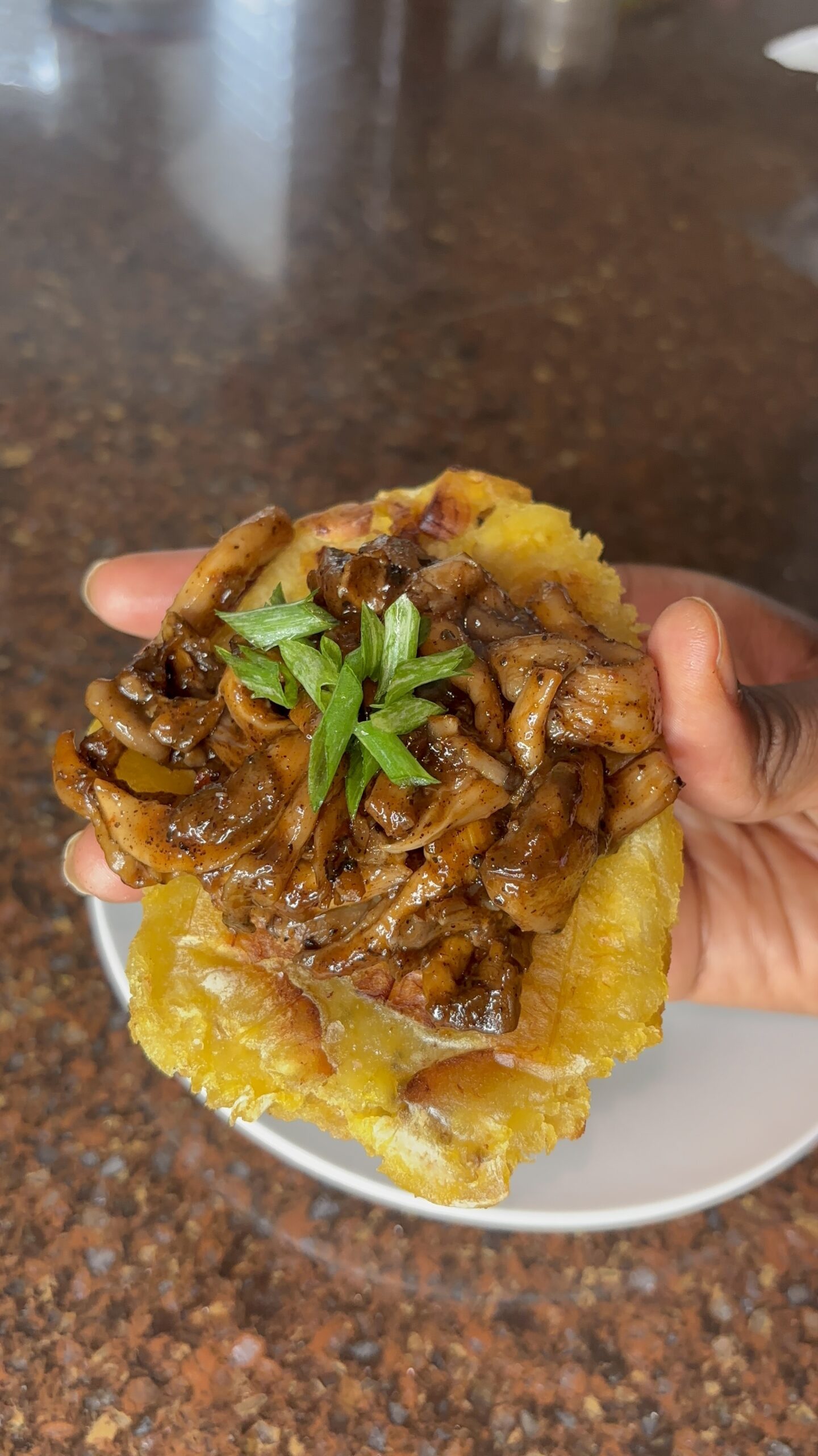 Green plantain to stones with jerk mushrooms topped with scallion
